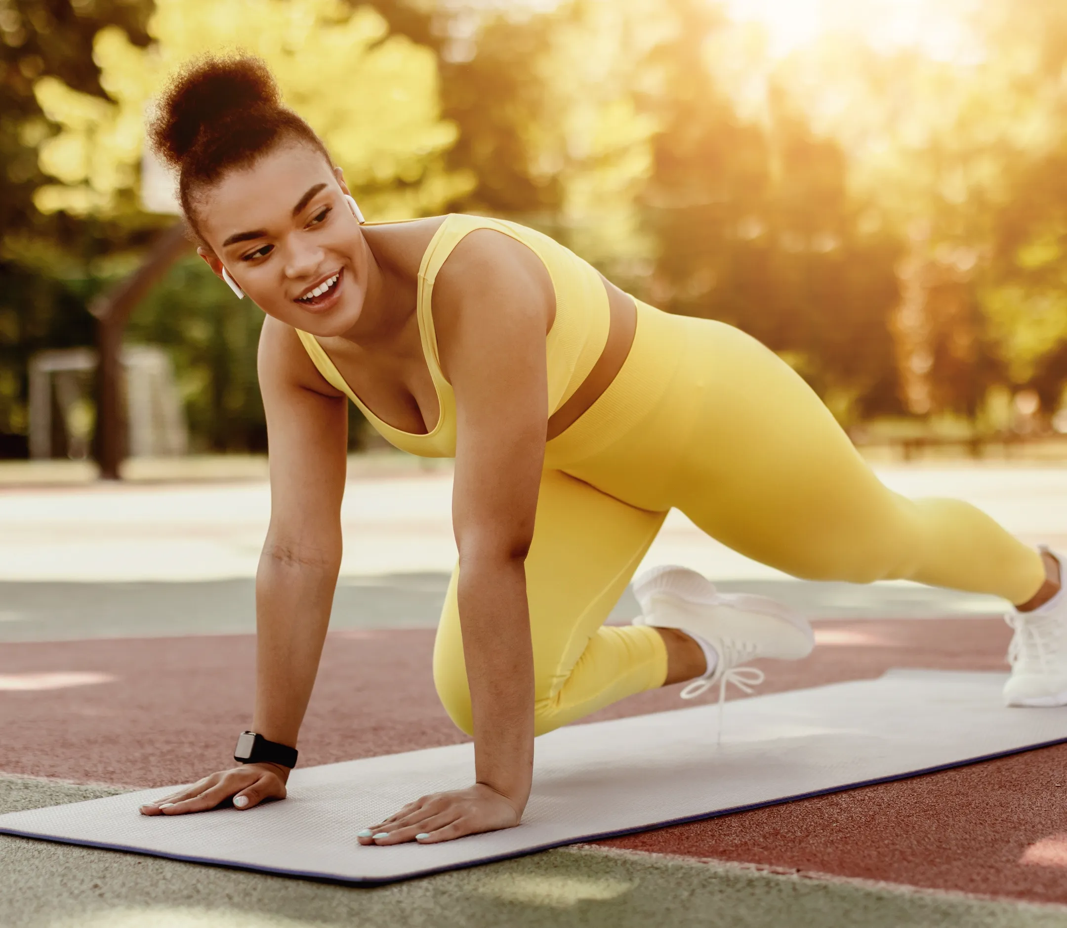 black cheerful woman doing cross body mountain cli utc