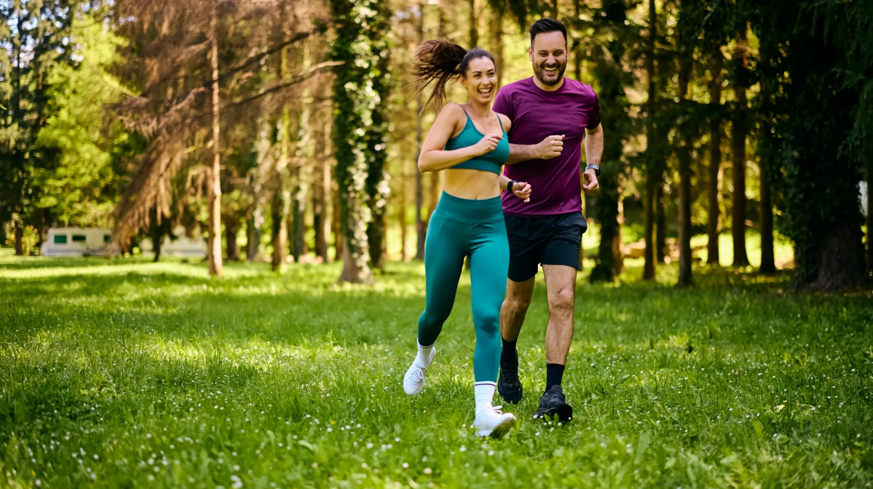 cheerful athletic couple jogging in the park utc