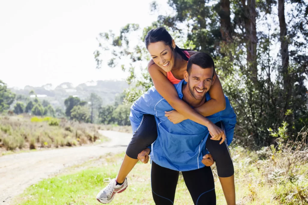 female jogger riding piggyback on man utc