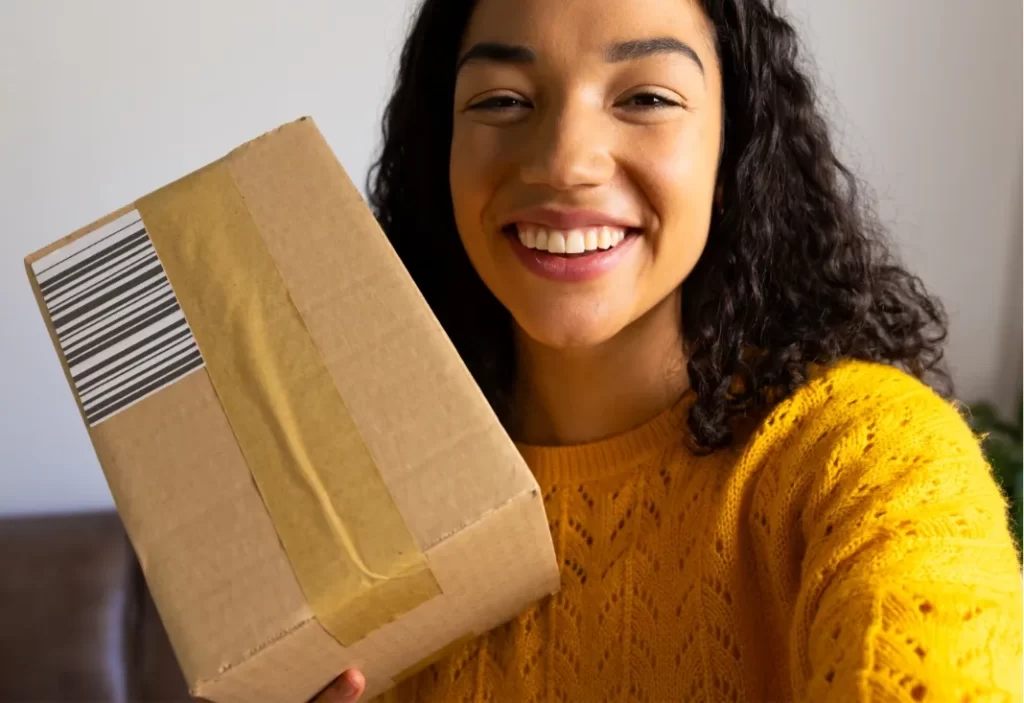 happy biracial woman in yellow sweater holding pac utc