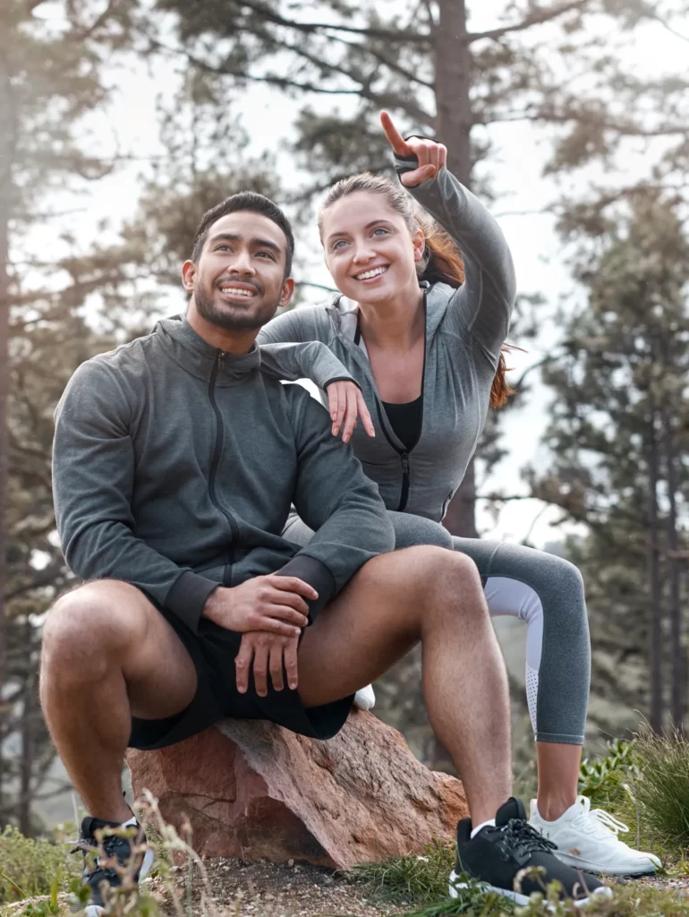 shot of a sporty young man and woman taking a brea utc