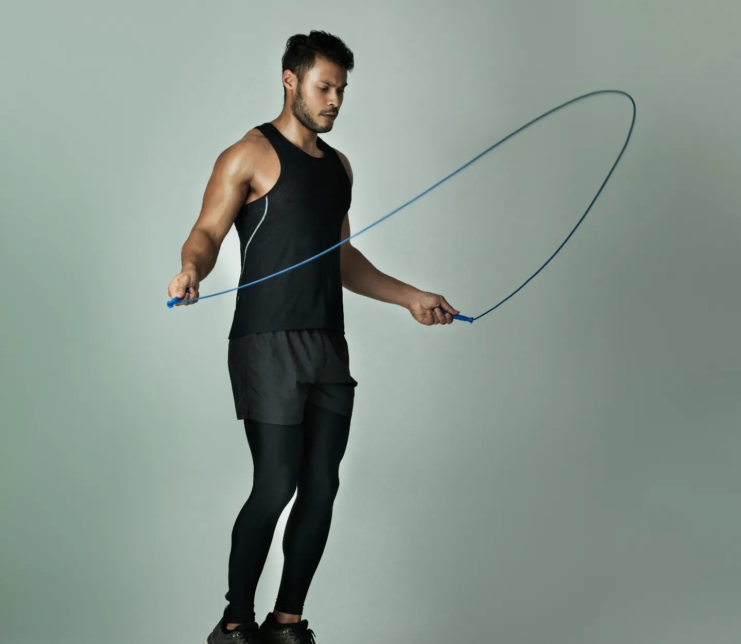 studio shot of a young man skipping with a jump ro utc