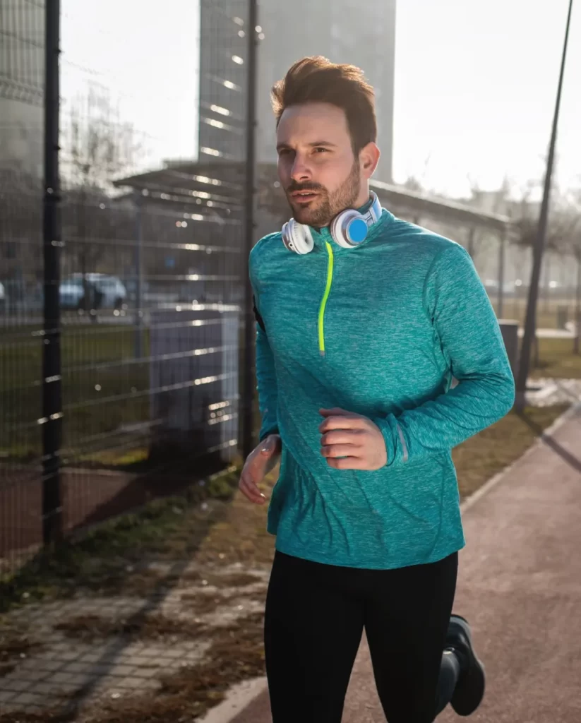 young fitness man running in urban area utc