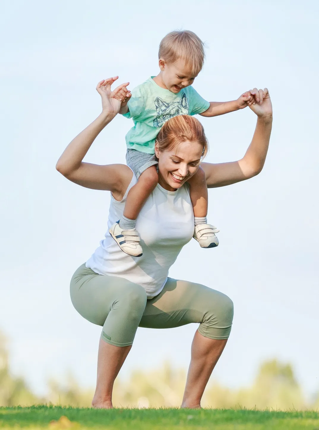 young fitness woman working out with son on should utc